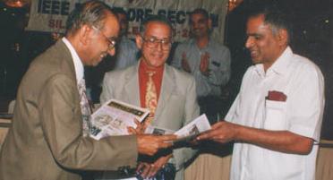 Mr Hiriyannaiah,Founder secretary issuing the copy of Special silver jubilee issue of Broadcast to Chief guest,  Prof. Sadagopan. Prof. Sankaran in the middle)